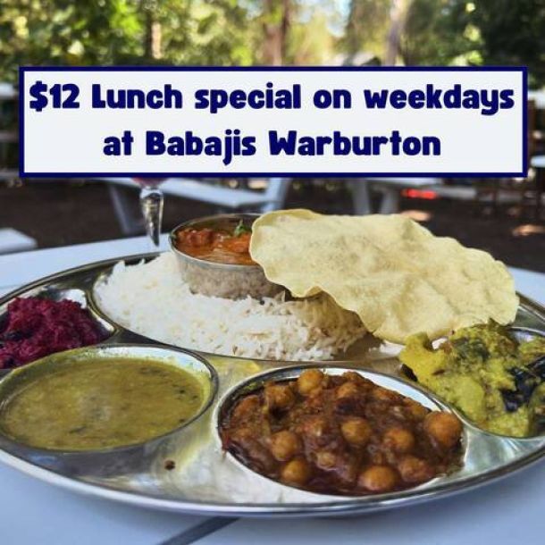 A plate of five south indian curries sits on a table overlooking the yarra river